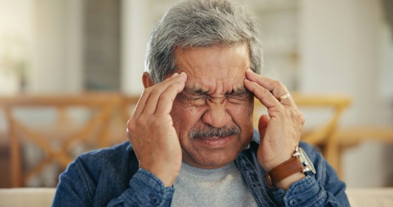 Headache, senior man and stress in home for mistake, mental health and brain fog in retirement. Fac